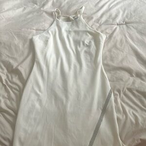White cocktail dress with silver embellishment along the bottom hem, worn once.